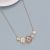 Elegant Gold Tone Necklace with Chunky Peach and Grey Tone Shapes 