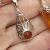 Sterling Silver Baltic Amber Pendant framed with a delicate Art Nouveau infinity design measuring approximately 29 mm long 